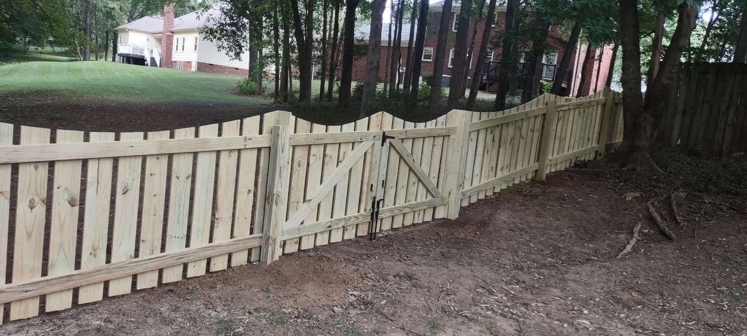 Wooden fence with gate in a yard.