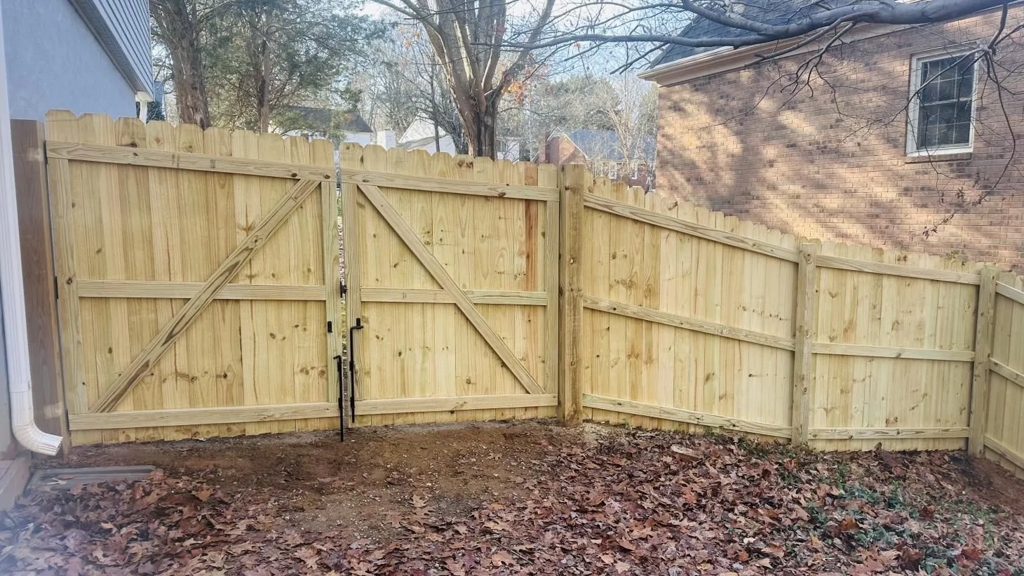 Wooden fence gate in a backyard setting.