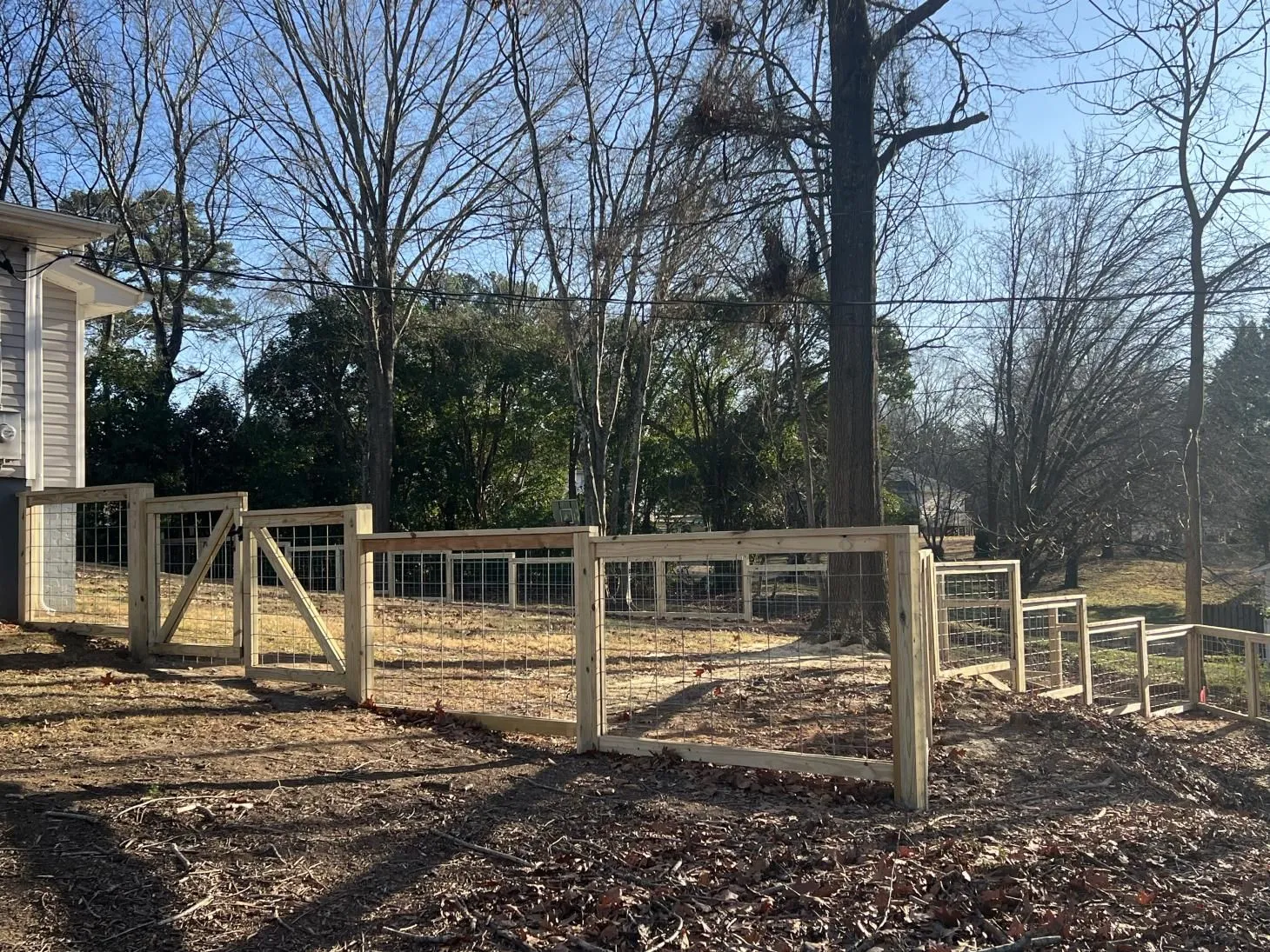 Wooden fence in a sunny backyard scene.