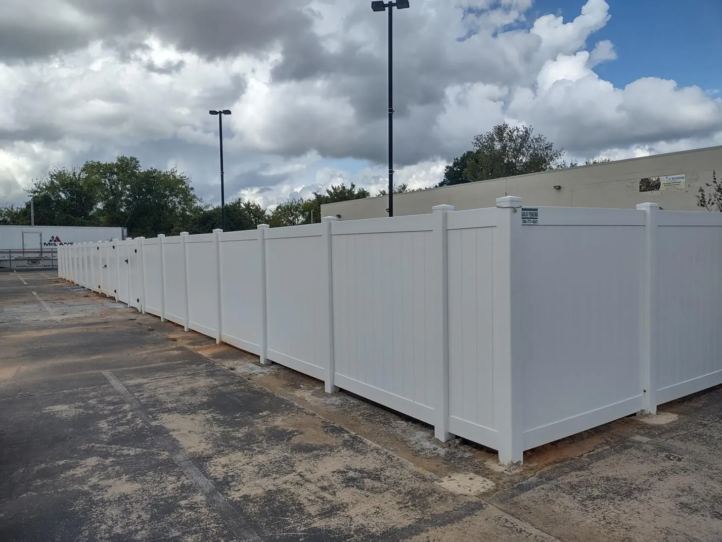 White fence surrounding an outdoor area.
