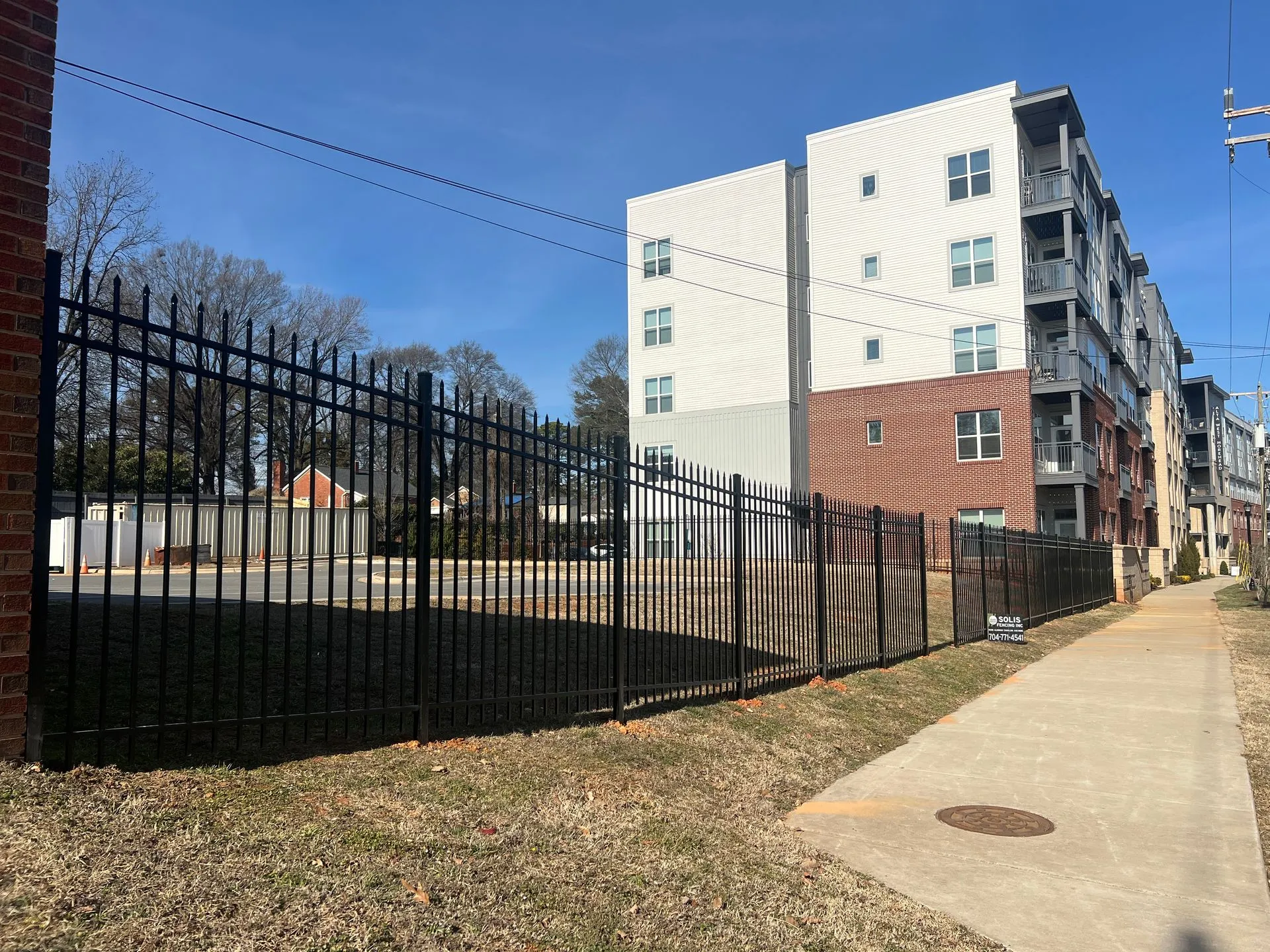 Apartment buildings with a black metal fence.