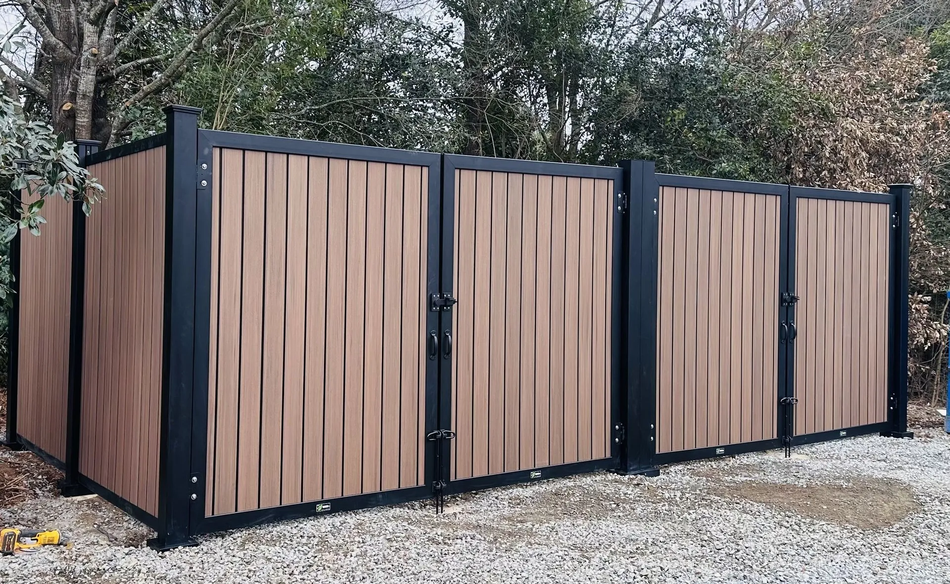 Wooden fence enclosure with black metal frame.