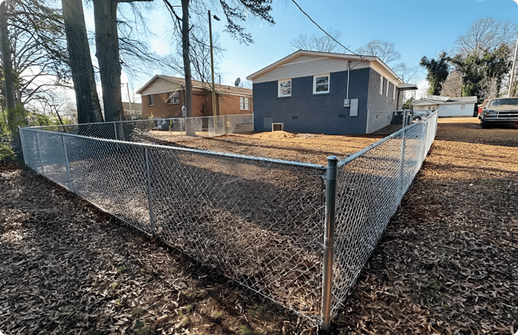 Chain-link fence around a suburban yard.