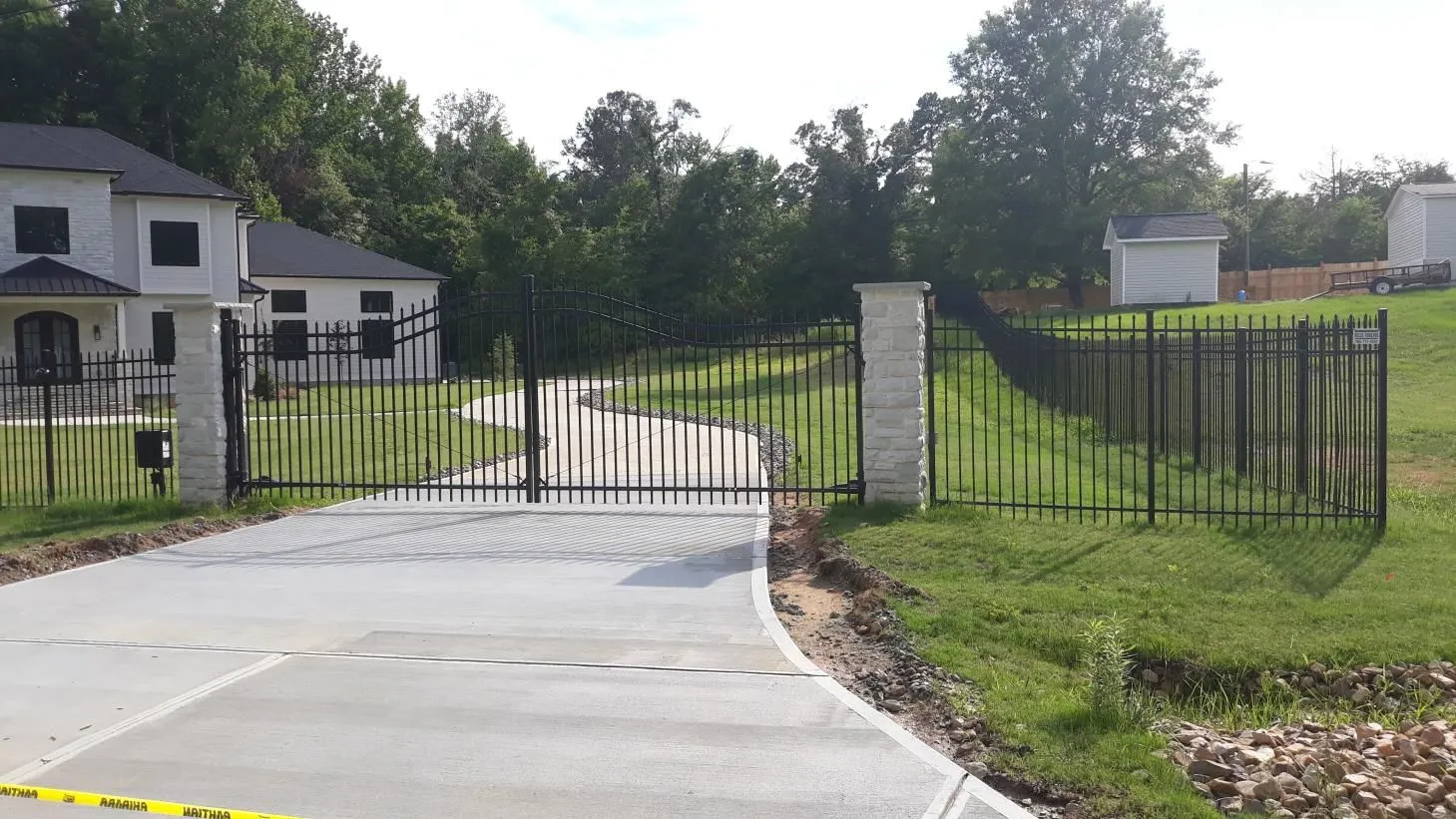 Driveway gate leading to suburban house.