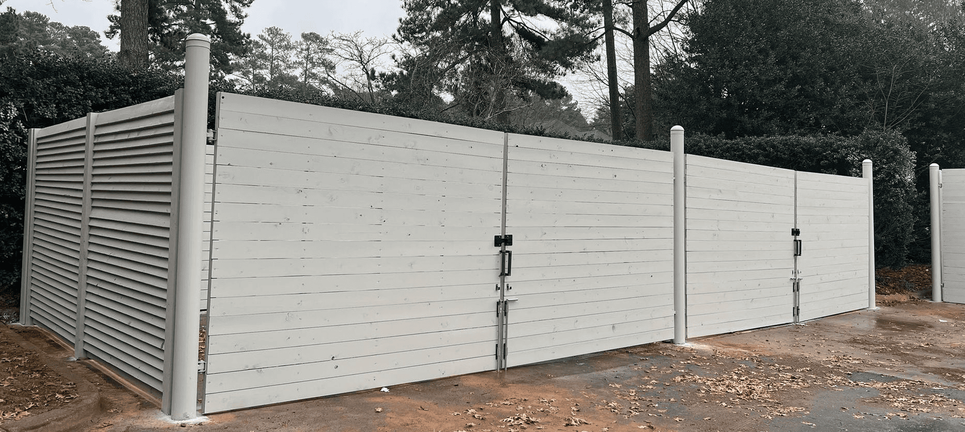 White wooden fence enclosure in outdoor area.