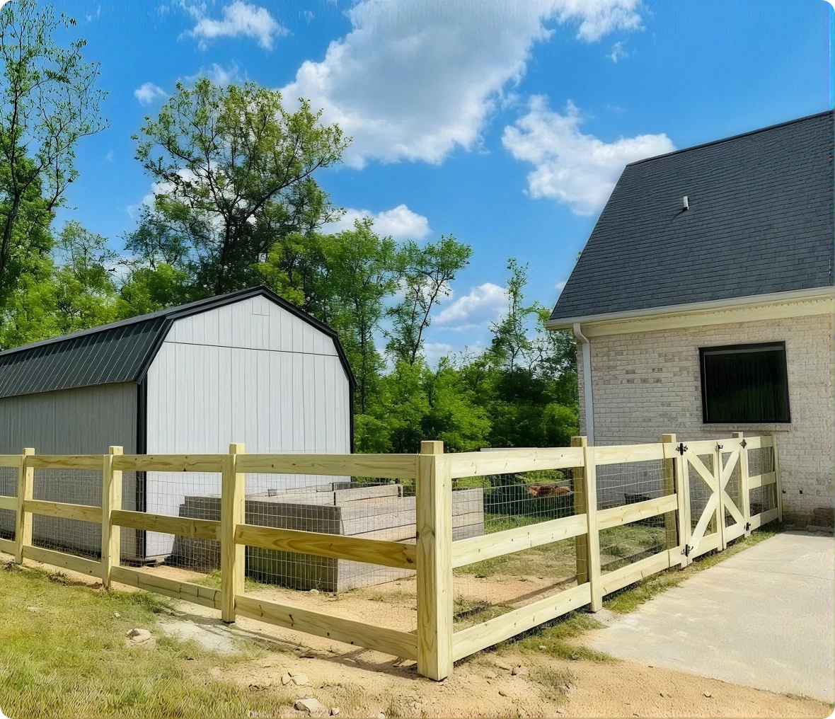 House and shed with wooden fence outside.