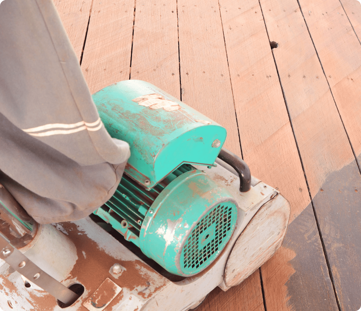 Floor sander on wooden deck in use.