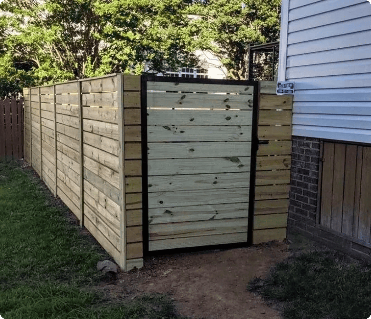 Wooden privacy fence beside a house.