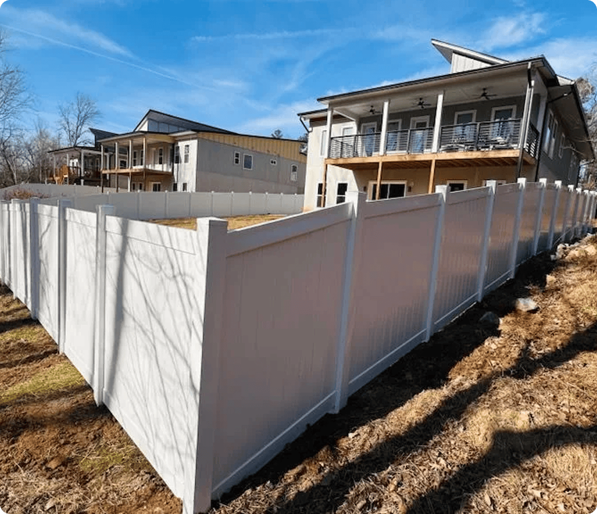 House with white fence and blue sky.