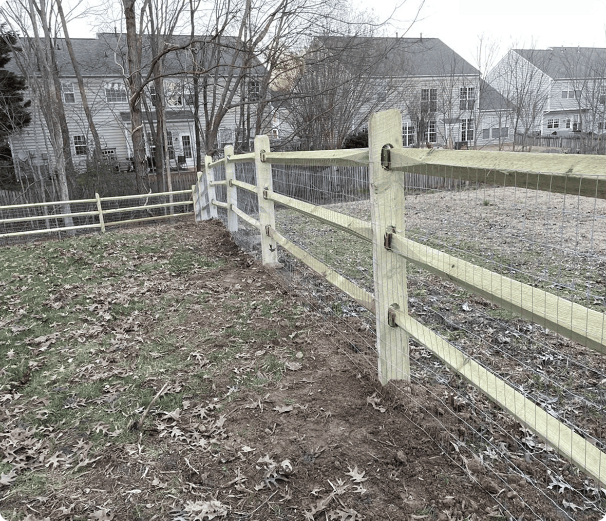Wooden fence dividing suburban backyards.