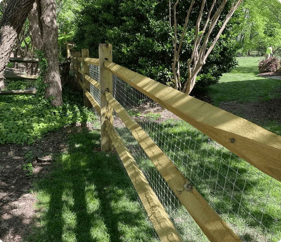 Wooden fence with wire in sunny garden.