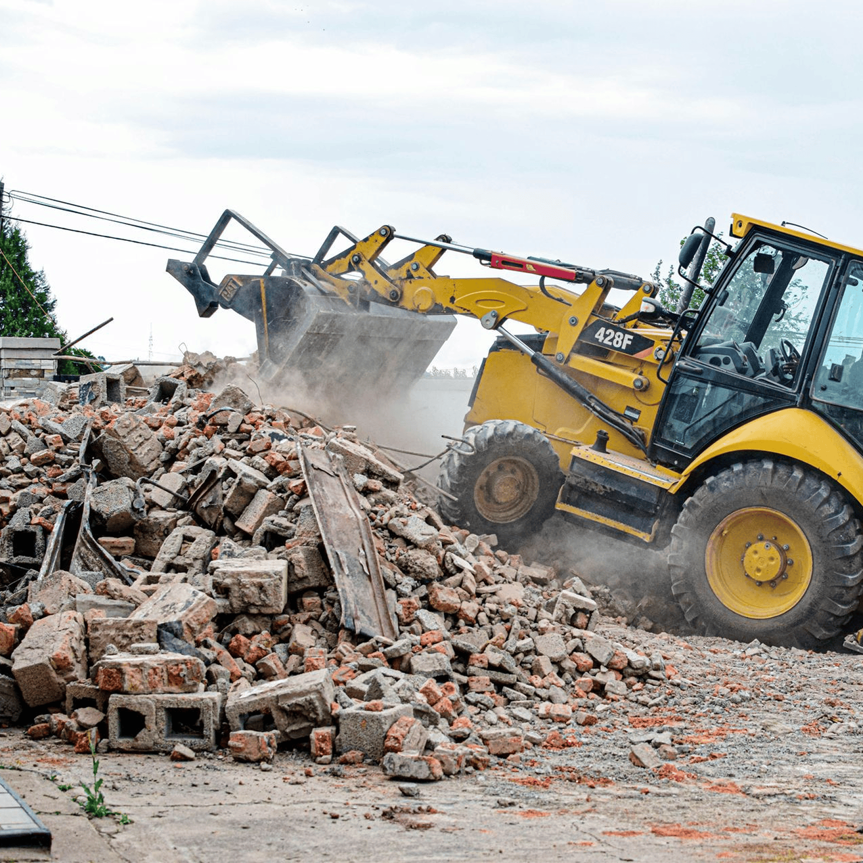 Bulldozer moving rubble at construction site.