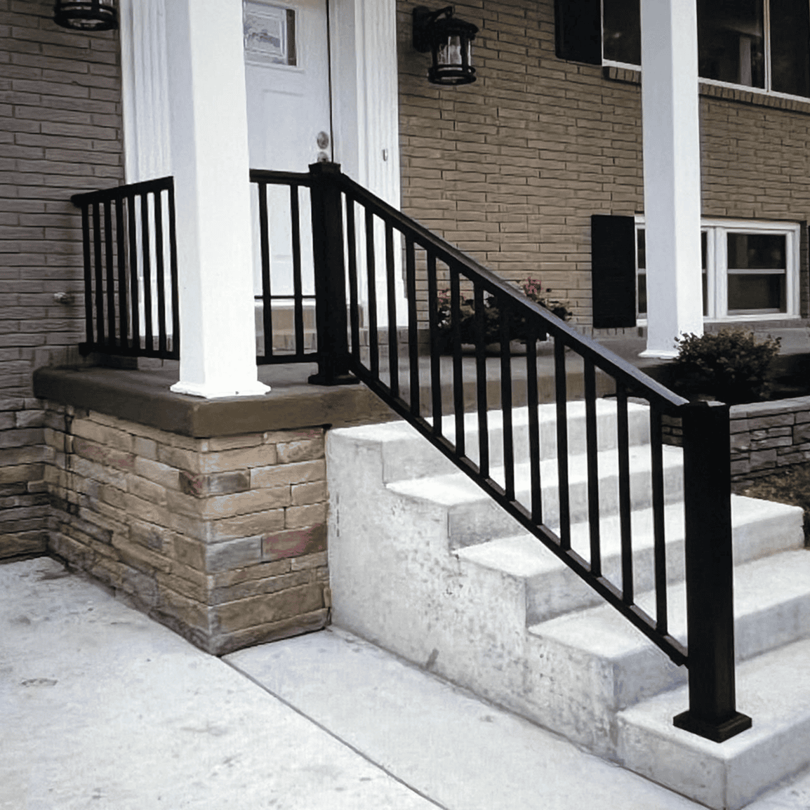 Brick house with steps and railing.