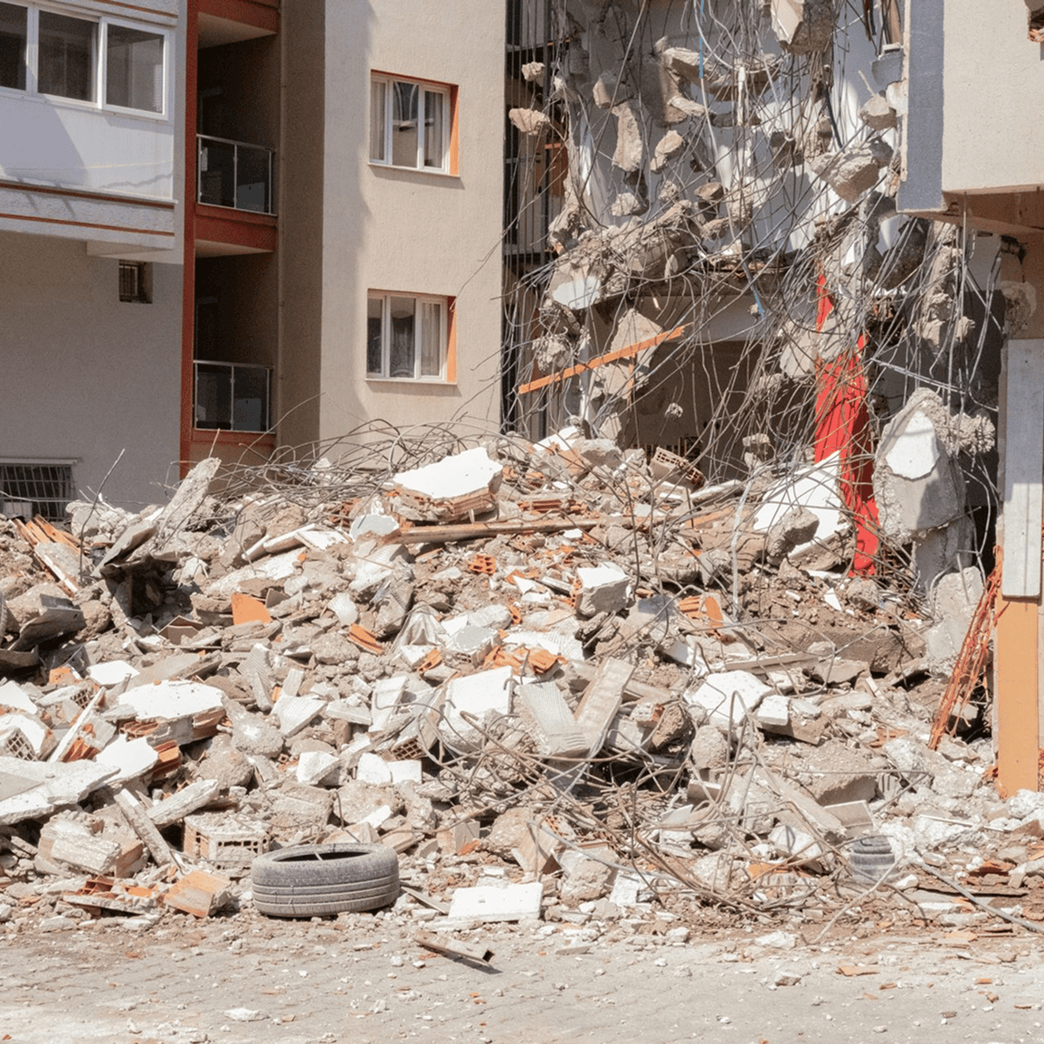Building rubble with exposed rebar and debris.