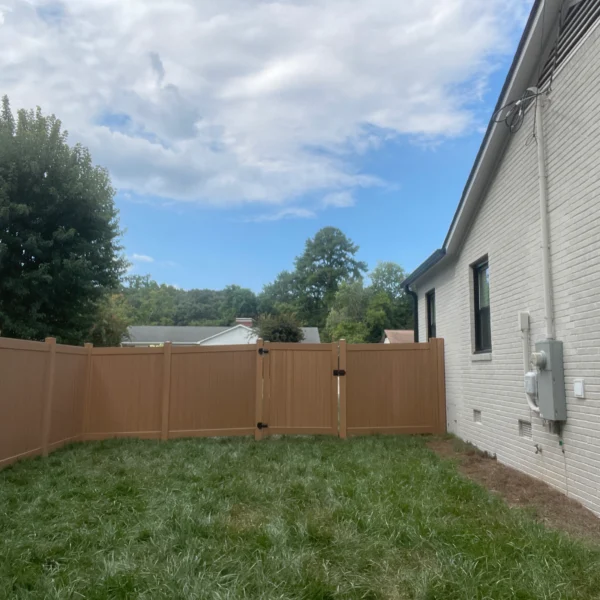 A well-maintained lawn surrounded by a wooden fence, creating a private and inviting backyard environment.